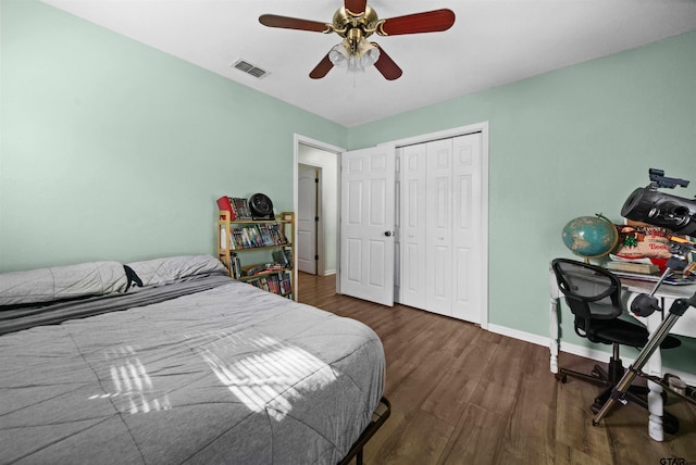 bedroom featuring a closet, dark hardwood / wood-style floors, and ceiling fan