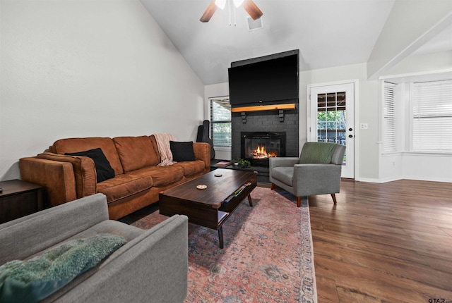 living room with ceiling fan, a fireplace, dark hardwood / wood-style floors, and high vaulted ceiling