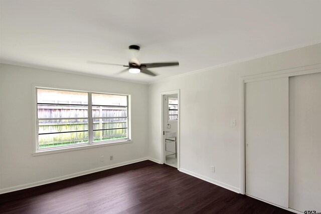 1301 Roseland Blvd, Tyler, TX 75701 - unfurnished bedroom featuring multiple windows, dark wood-style flooring, crown molding, connected bathroom, and ceiling fan