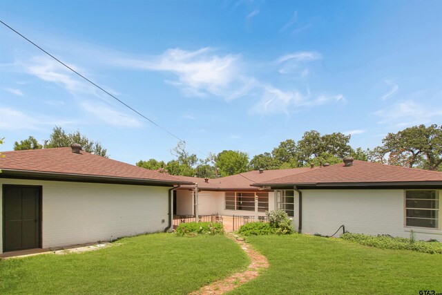 1301 Roseland Blvd, Tyler, TX 75701 - rear view of property featuring a lawn and a shingled roof