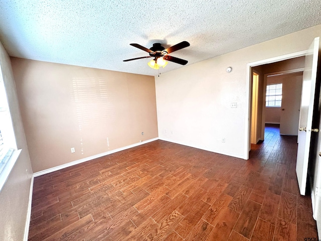 spare room with ceiling fan, dark hardwood / wood-style floors, and a textured ceiling