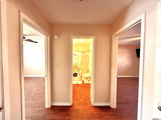 hall featuring hardwood / wood-style floors and a textured ceiling