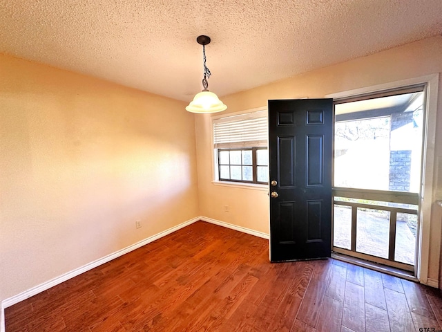 foyer with a textured ceiling and dark hardwood / wood-style flooring