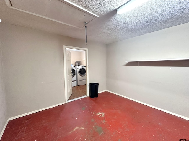 interior space featuring separate washer and dryer and a textured ceiling