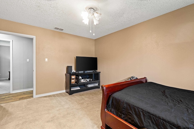 2207 Pinecrest Dr, Gladewater, TX 75647 - bedroom with visible vents, baseboards, carpet flooring, and a textured ceiling