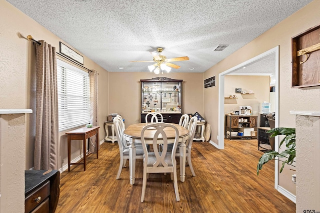 2207 Pinecrest Dr, Gladewater, TX 75647 - dining space featuring a textured ceiling, wood finished floors, a ceiling fan, and visible vents