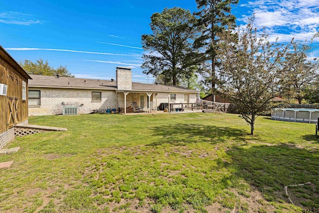 2207 Pinecrest Dr, Gladewater, TX 75647 - view of yard featuring cooling unit, an outdoor pool, and a patio area