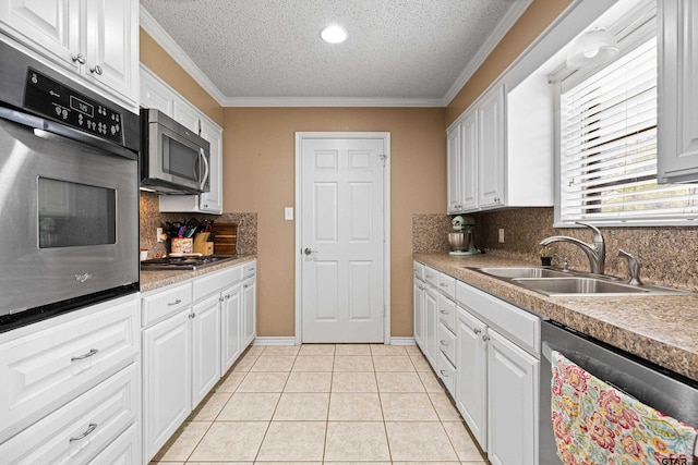 2207 Pinecrest Dr, Gladewater, TX 75647 - kitchen with light tile patterned flooring, white cabinetry, a sink, and appliances with stainless steel finishes