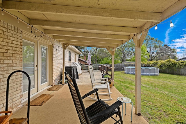 2207 Pinecrest Dr, Gladewater, TX 75647 - view of patio / terrace featuring a grill, a fenced backyard, and a fenced in pool