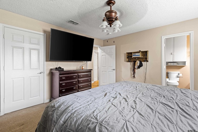 2207 Pinecrest Dr, Gladewater, TX 75647 - carpeted bedroom featuring visible vents and a textured ceiling
