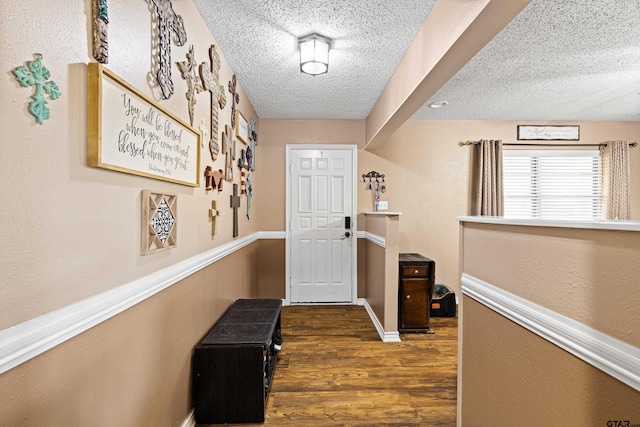 2207 Pinecrest Dr, Gladewater, TX 75647 - corridor featuring a textured ceiling, baseboards, and dark wood-style floors