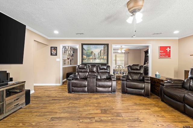 2207 Pinecrest Dr, Gladewater, TX 75647 - living area with ornamental molding, ceiling fan, wood finished floors, and a textured ceiling
