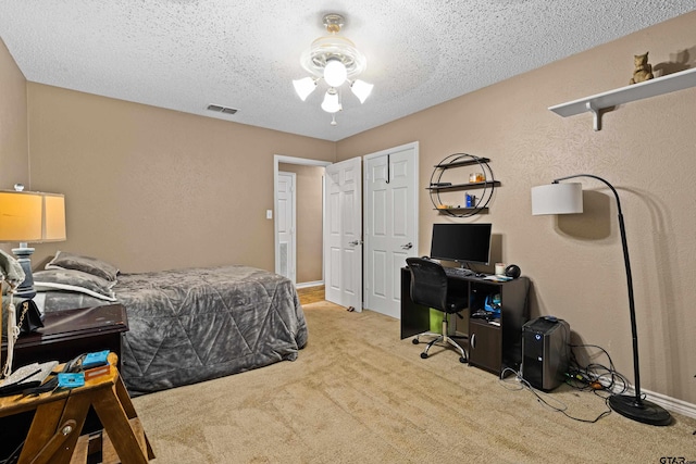 2207 Pinecrest Dr, Gladewater, TX 75647 - bedroom with a textured ceiling, carpet flooring, baseboards, and visible vents