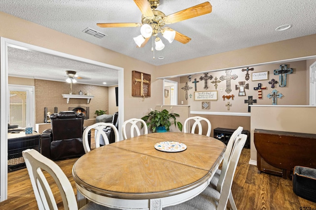 2207 Pinecrest Dr, Gladewater, TX 75647 - dining space with a textured ceiling, wood finished floors, ceiling fan, and visible vents