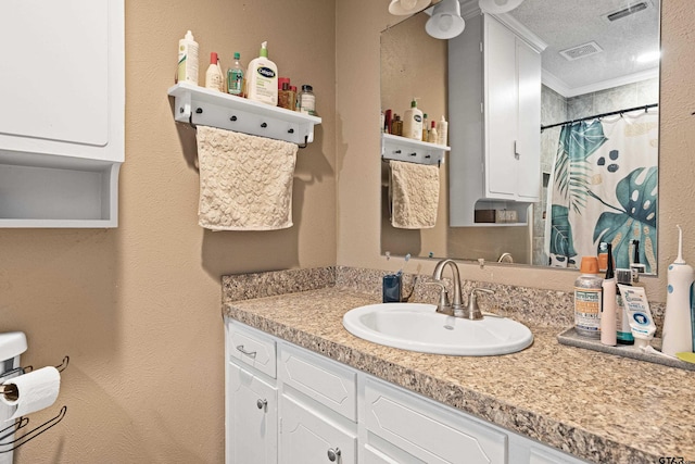 2207 Pinecrest Dr, Gladewater, TX 75647 - bathroom with crown molding, visible vents, vanity, and a textured ceiling