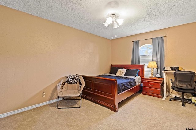 2207 Pinecrest Dr, Gladewater, TX 75647 - carpeted bedroom featuring baseboards, a textured wall, and a textured ceiling