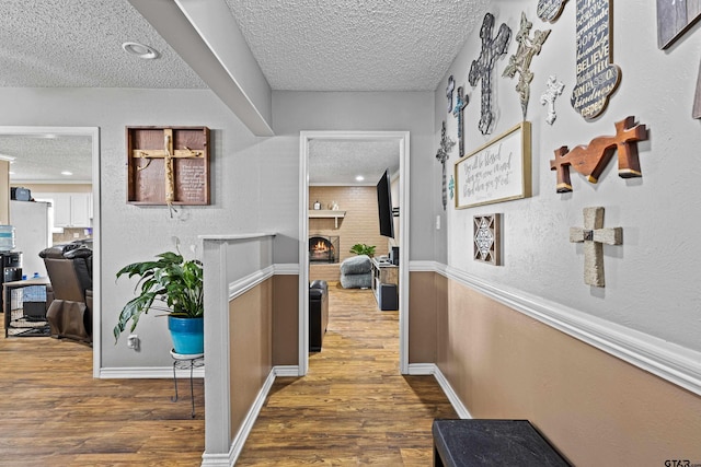 2207 Pinecrest Dr, Gladewater, TX 75647 - corridor featuring recessed lighting, a textured ceiling, baseboards, and wood finished floors