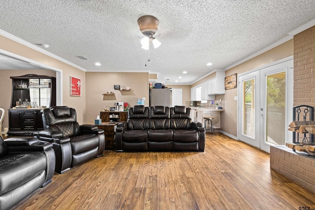 2207 Pinecrest Dr, Gladewater, TX 75647 - living area featuring a ceiling fan, light wood-style floors, french doors, and ornamental molding