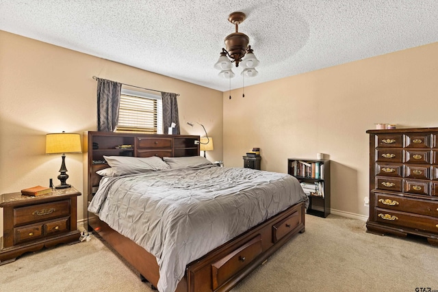 2207 Pinecrest Dr, Gladewater, TX 75647 - bedroom with baseboards, a ceiling fan, light colored carpet, and a textured ceiling