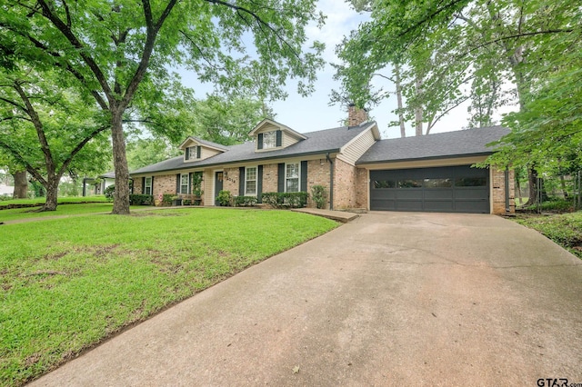 1018 Pollard Dr, Tyler, TX 75701 - view of front facade featuring brick siding, driveway, a garage, and a front yard