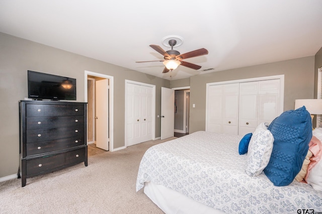 1018 Pollard Dr, Tyler, TX 75701 - bedroom featuring two closets, carpet flooring, baseboards, and a ceiling fan