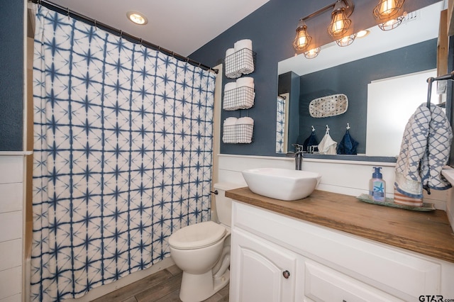1018 Pollard Dr, Tyler, TX 75701 - full bathroom with vanity, toilet, wood finished floors, and a shower with curtain