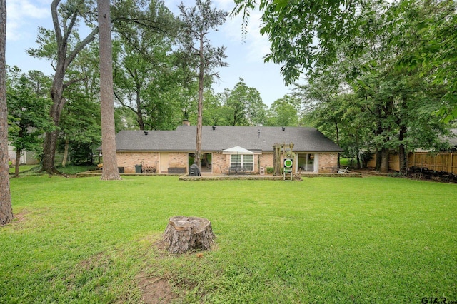 1018 Pollard Dr, Tyler, TX 75701 - rear view of house with brick siding and a chimney