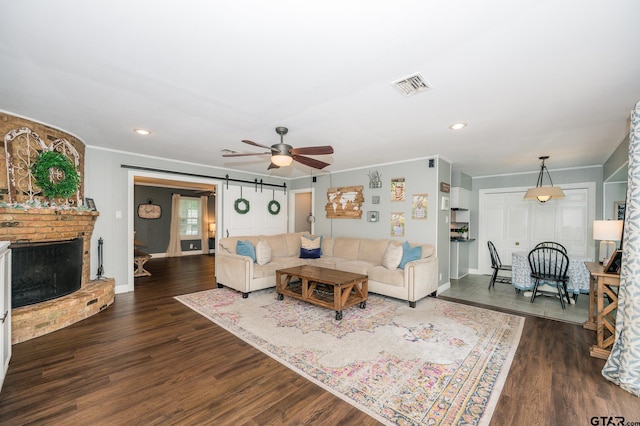 1018 Pollard Dr, Tyler, TX 75701 - living room with ornamental molding, a ceiling fan, dark wood-type flooring, baseboards, and recessed lighting