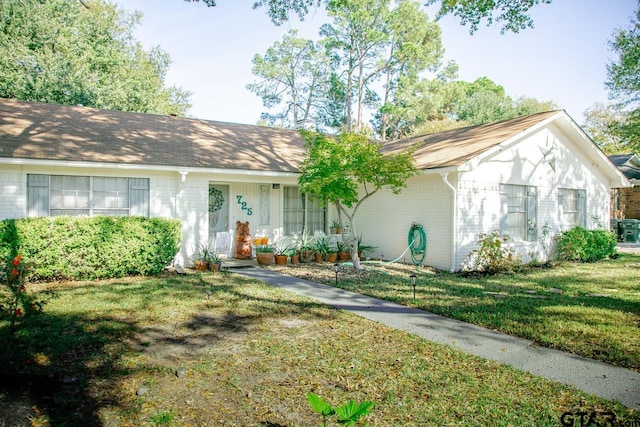 ranch-style house with a front lawn