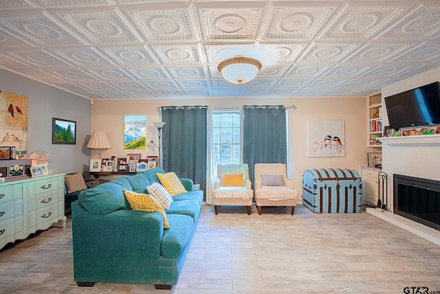 living room with built in shelves and light hardwood / wood-style floors