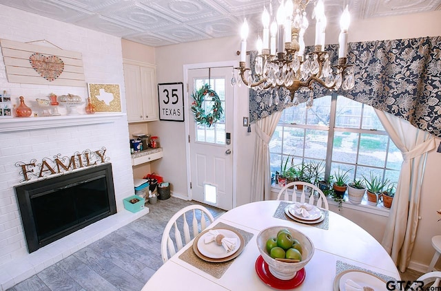 dining area with wood-type flooring and a chandelier