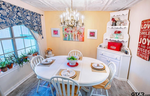 dining area with a notable chandelier and dark hardwood / wood-style floors