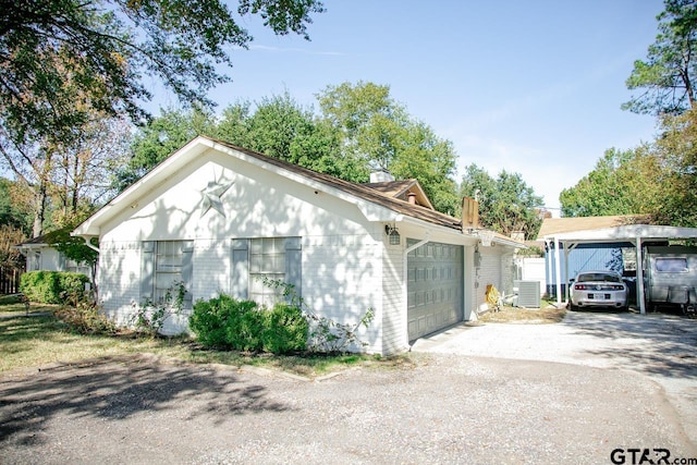 view of front of house featuring central AC and a garage