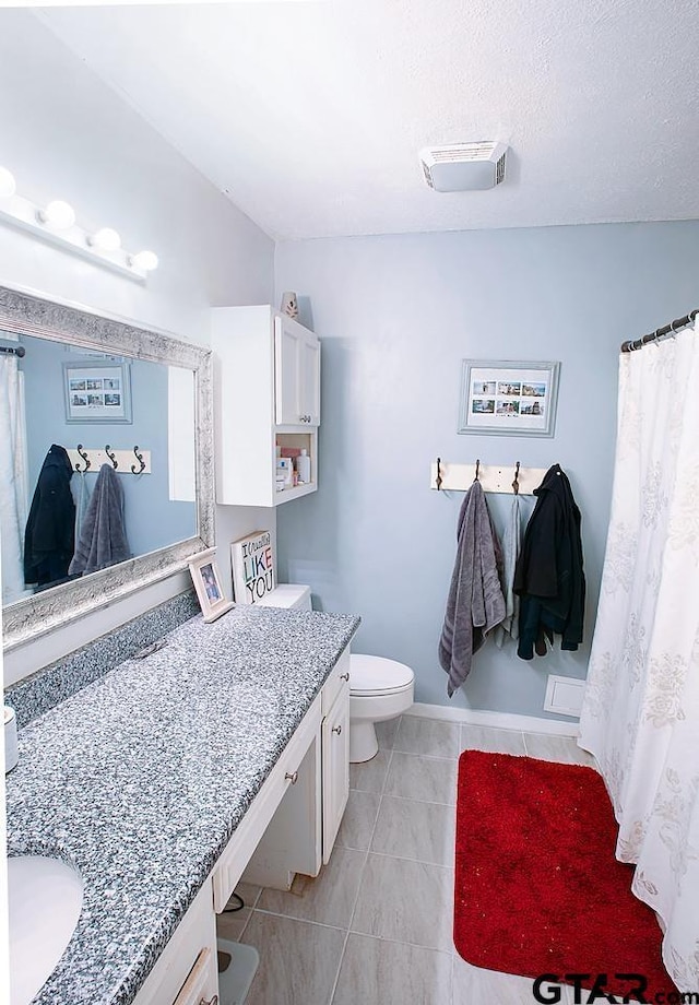 bathroom with tile patterned floors, vanity, and toilet