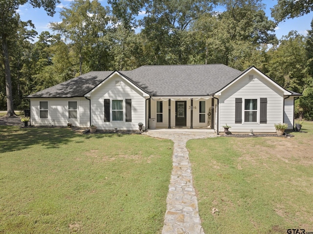 ranch-style home with a front lawn and covered porch