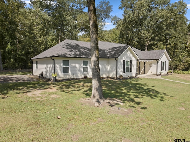 view of front of house with a front lawn and a patio area