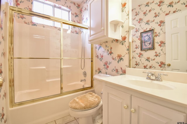 full bathroom featuring toilet, vanity, shower / bath combination with glass door, and tile patterned flooring