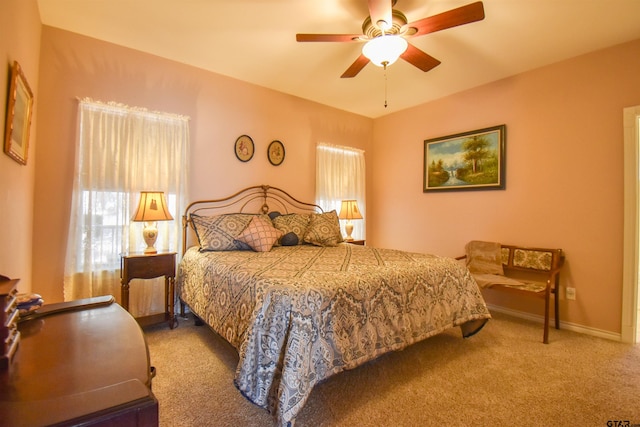 bedroom featuring light colored carpet and ceiling fan