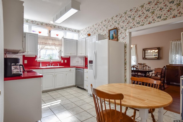 kitchen with white cabinetry, sink, white refrigerator with ice dispenser, and dishwasher