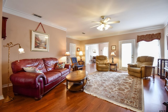 living room with ornamental molding, dark hardwood / wood-style floors, and ceiling fan