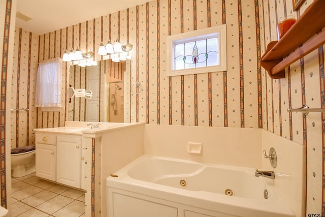 bathroom with a bathing tub, toilet, tile patterned floors, and vanity