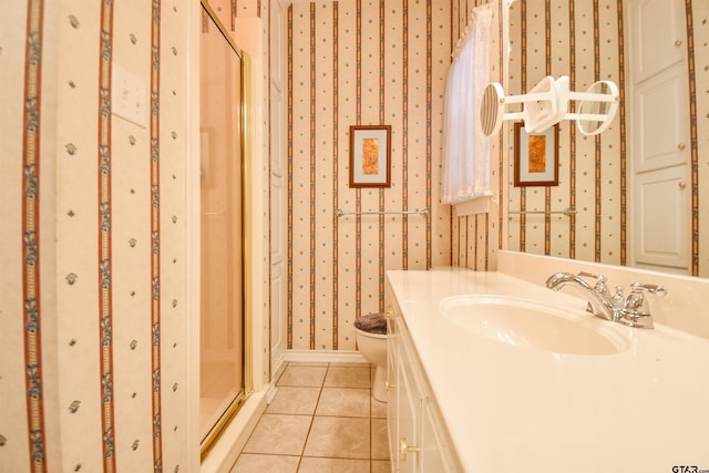 bathroom featuring a shower with door, vanity, tile patterned floors, and toilet