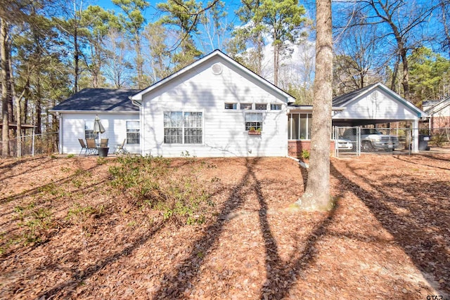 rear view of house featuring a carport