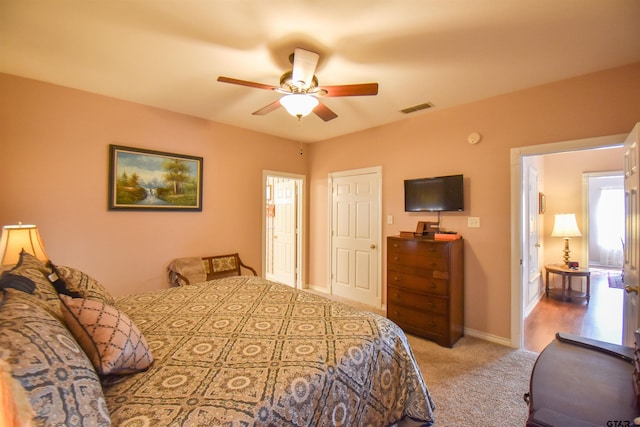 bedroom featuring light colored carpet and ceiling fan