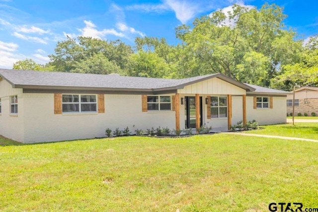8100 Jewell Ln, Tyler, TX 75703 - ranch-style home featuring a front lawn, brick siding, and a shingled roof