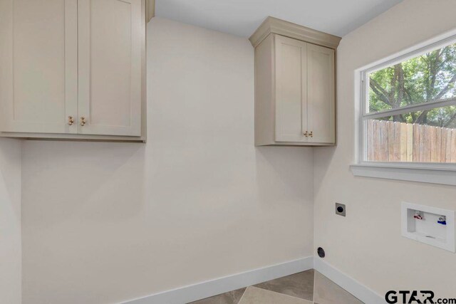 8100 Jewell Ln, Tyler, TX 75703 - washroom with cabinet space, electric dryer hookup, baseboards, and hookup for a washing machine