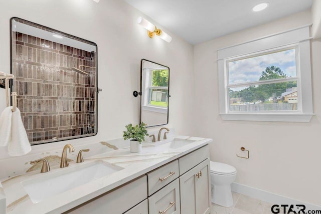 8100 Jewell Ln, Tyler, TX 75703 - full bath featuring toilet, double vanity, baseboards, and tile patterned floors
