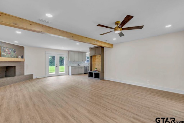 8100 Jewell Ln, Tyler, TX 75703 - unfurnished living room with a fireplace, recessed lighting, light wood-style floors, ceiling fan, and beam ceiling