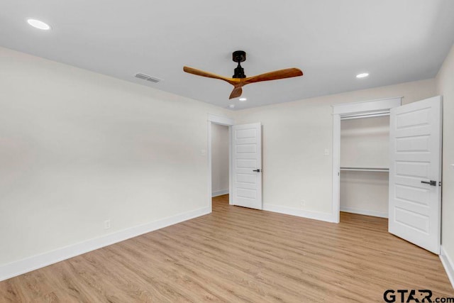 8100 Jewell Ln, Tyler, TX 75703 - unfurnished bedroom featuring light wood finished floors, baseboards, recessed lighting, and a walk in closet
