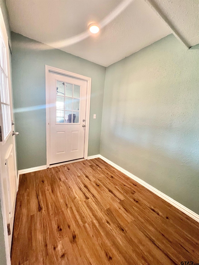 doorway to outside featuring hardwood / wood-style flooring, a healthy amount of sunlight, and a textured ceiling